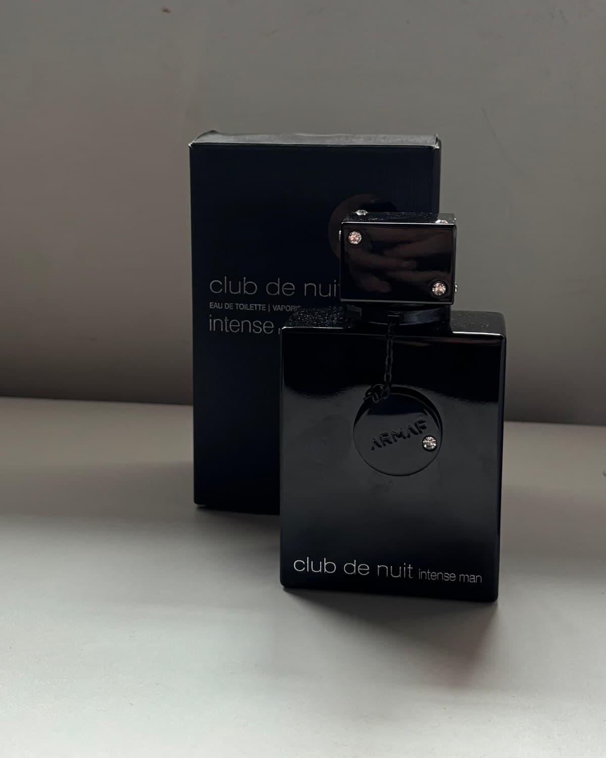 Armaf Club De Nuit Intense Man, frasco de 100 ml, sobre la mesa